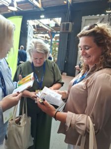 A guest sitting for an aura photography session at a corporate event with a colorful aura portrait.