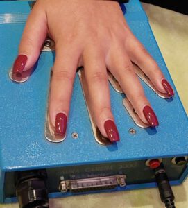 A guest sitting for an aura photography session at a corporate event with a colorful aura portrait.